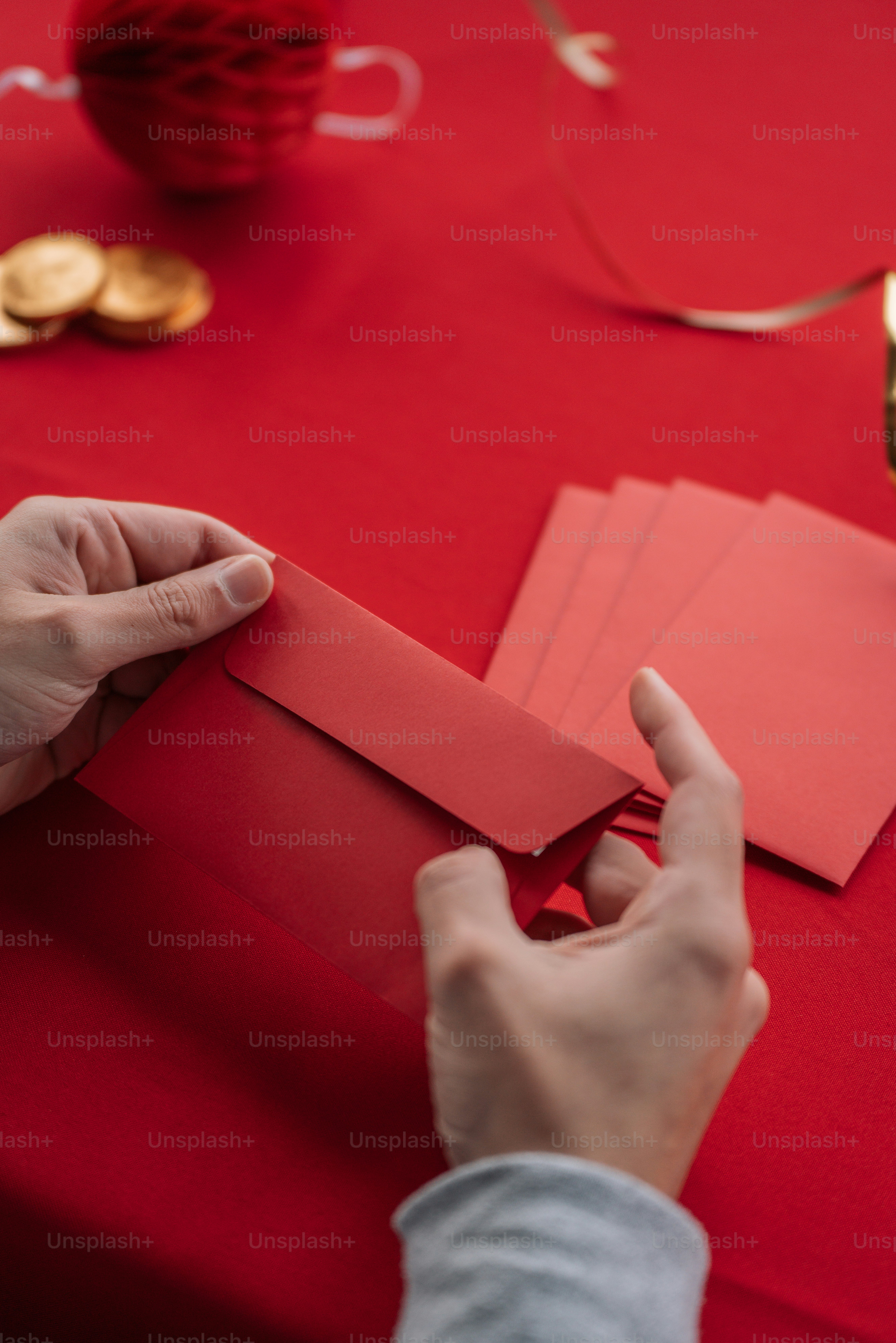 a person cutting out a piece of red paper