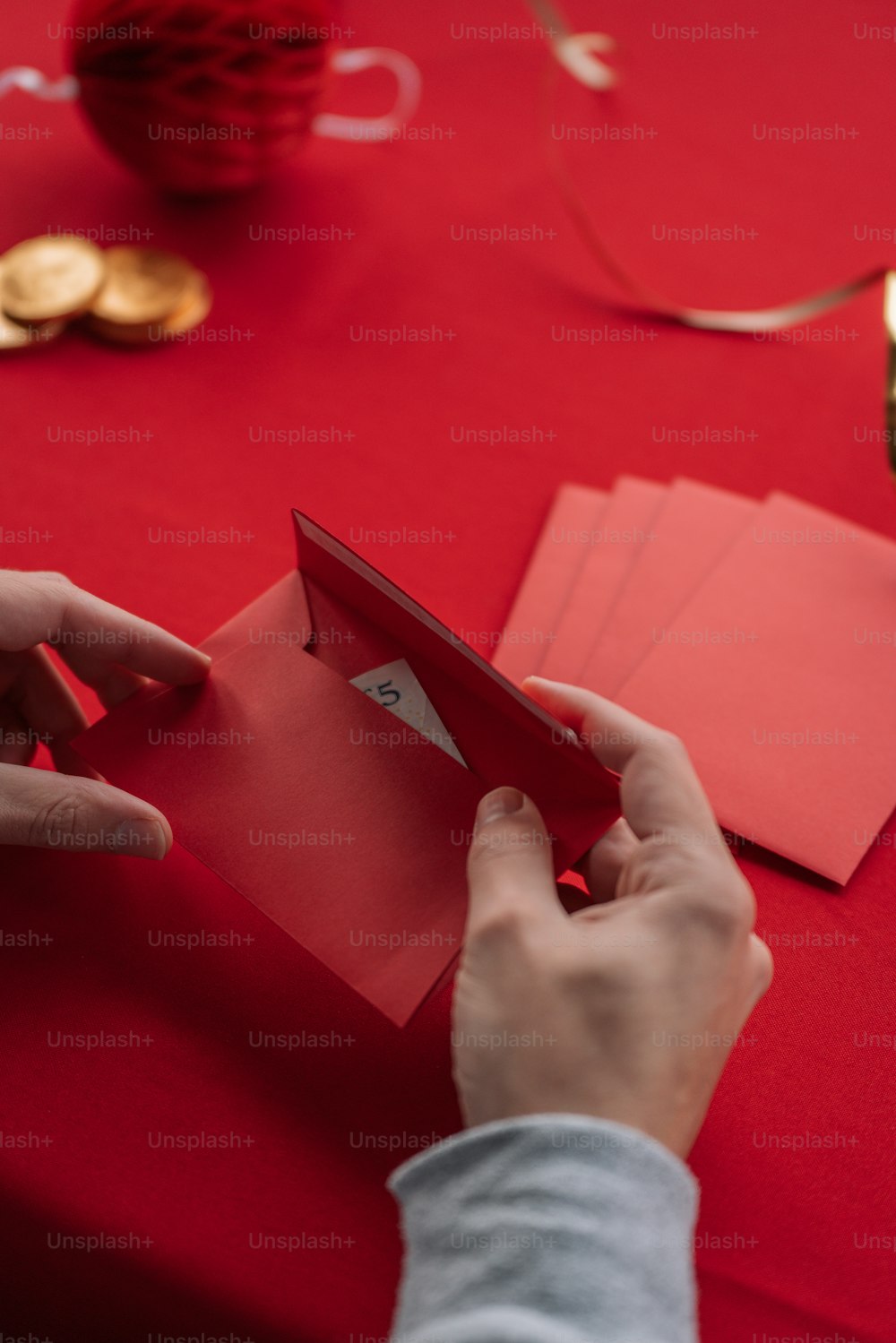 a person holding a piece of red paper