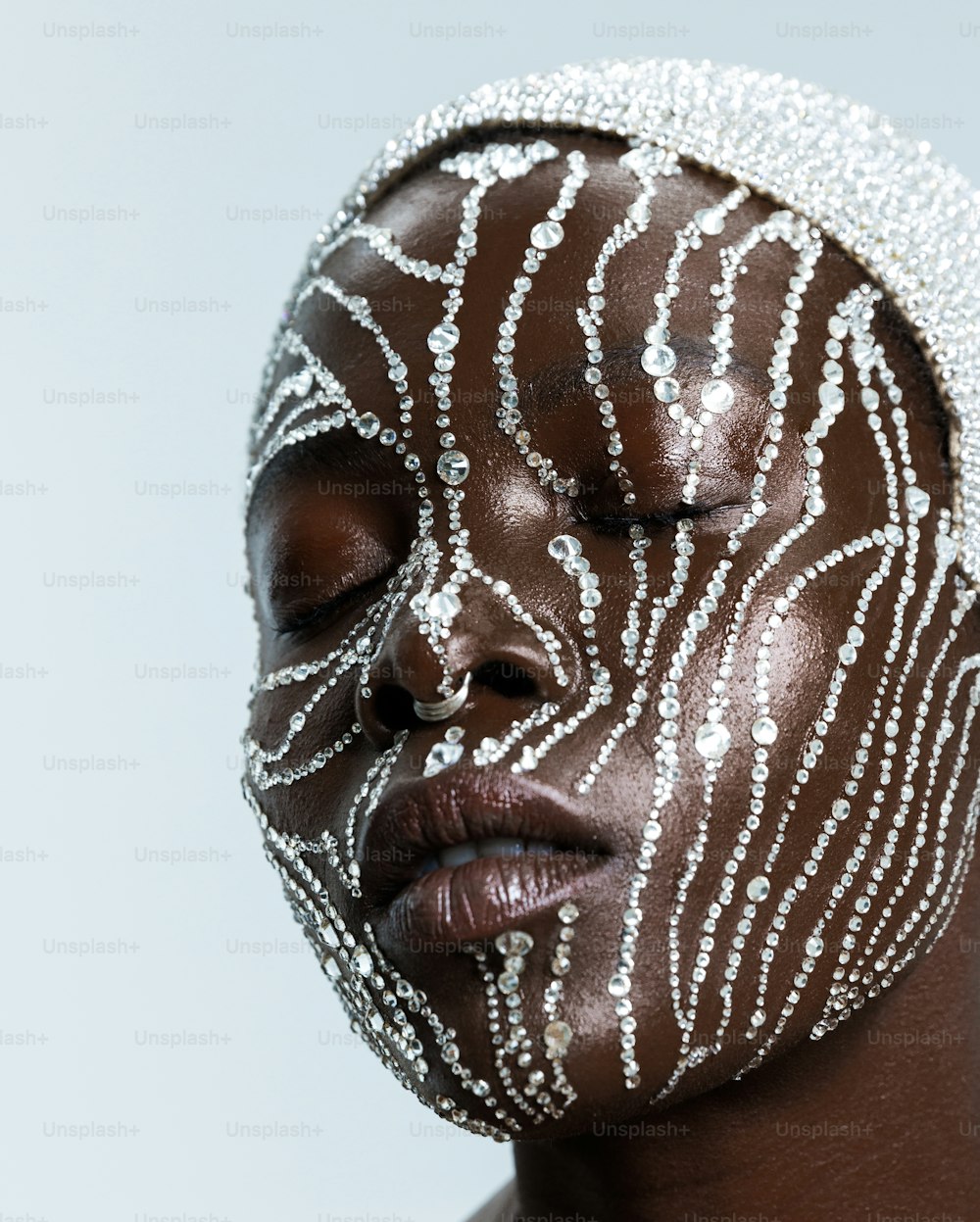 a woman wearing a white and silver face mask