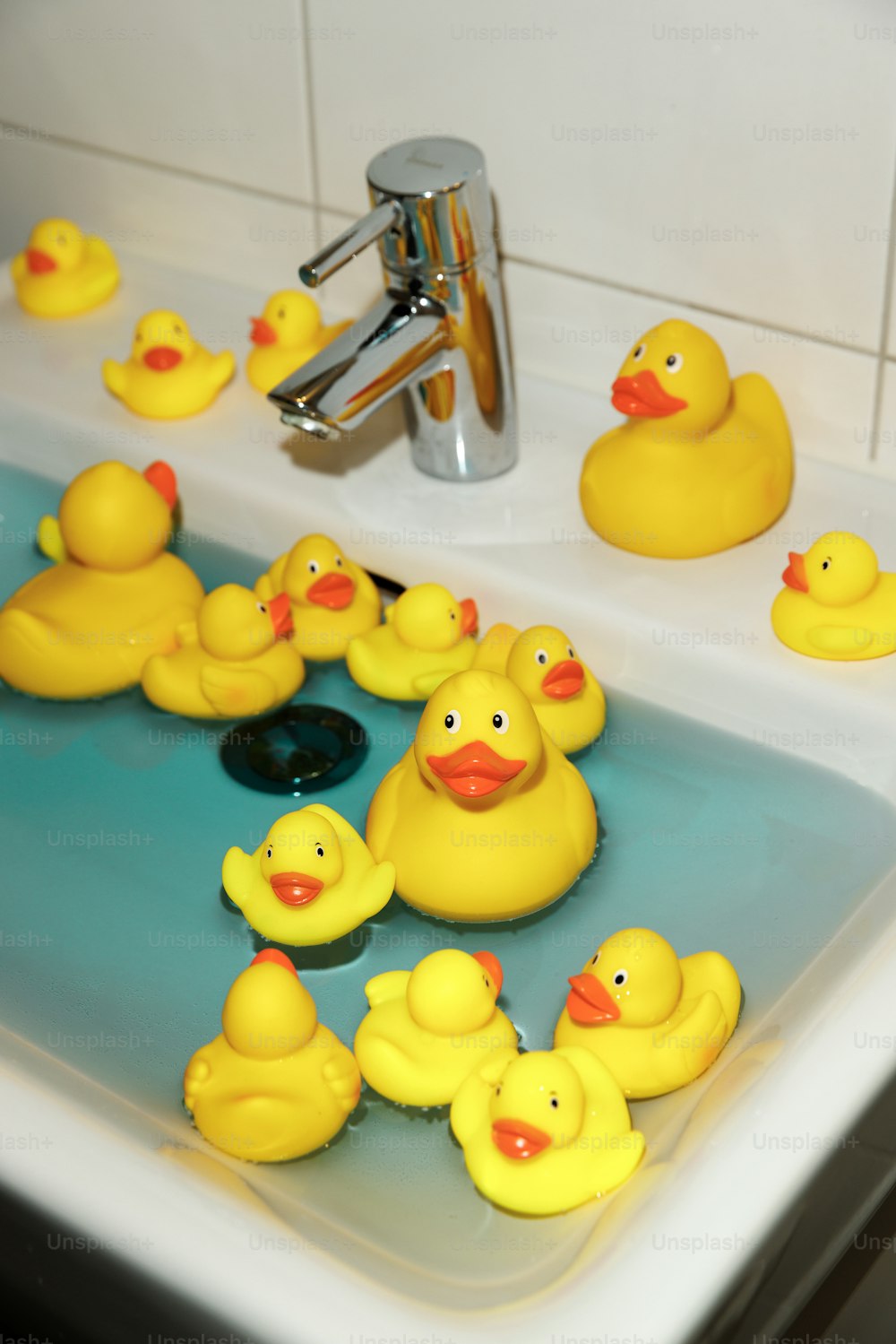 a group of rubber ducks in a sink