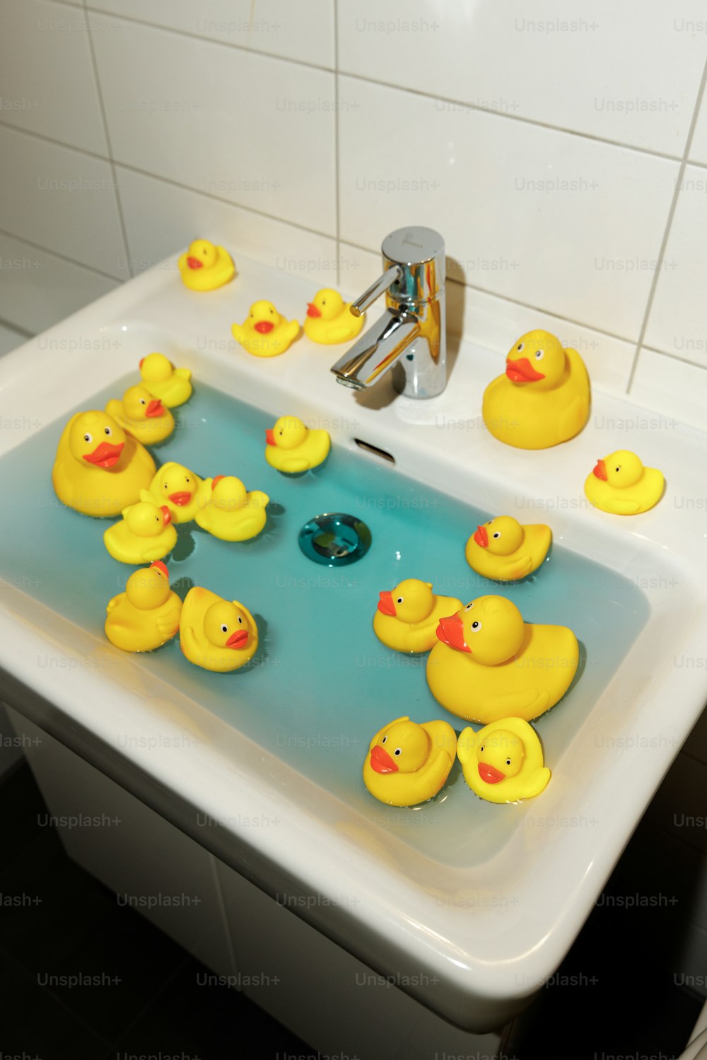 a group of rubber ducks in a sink