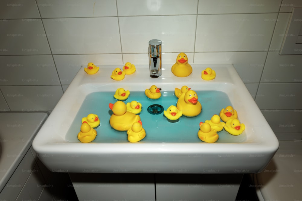 a sink with yellow ducks in it
