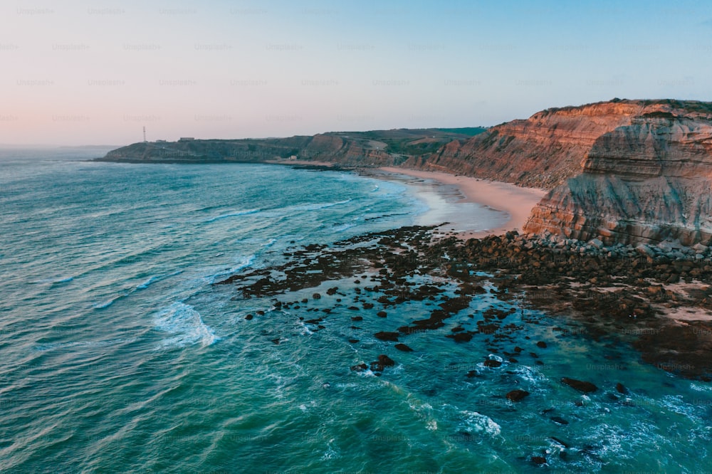 an aerial view of a beach and cliffs