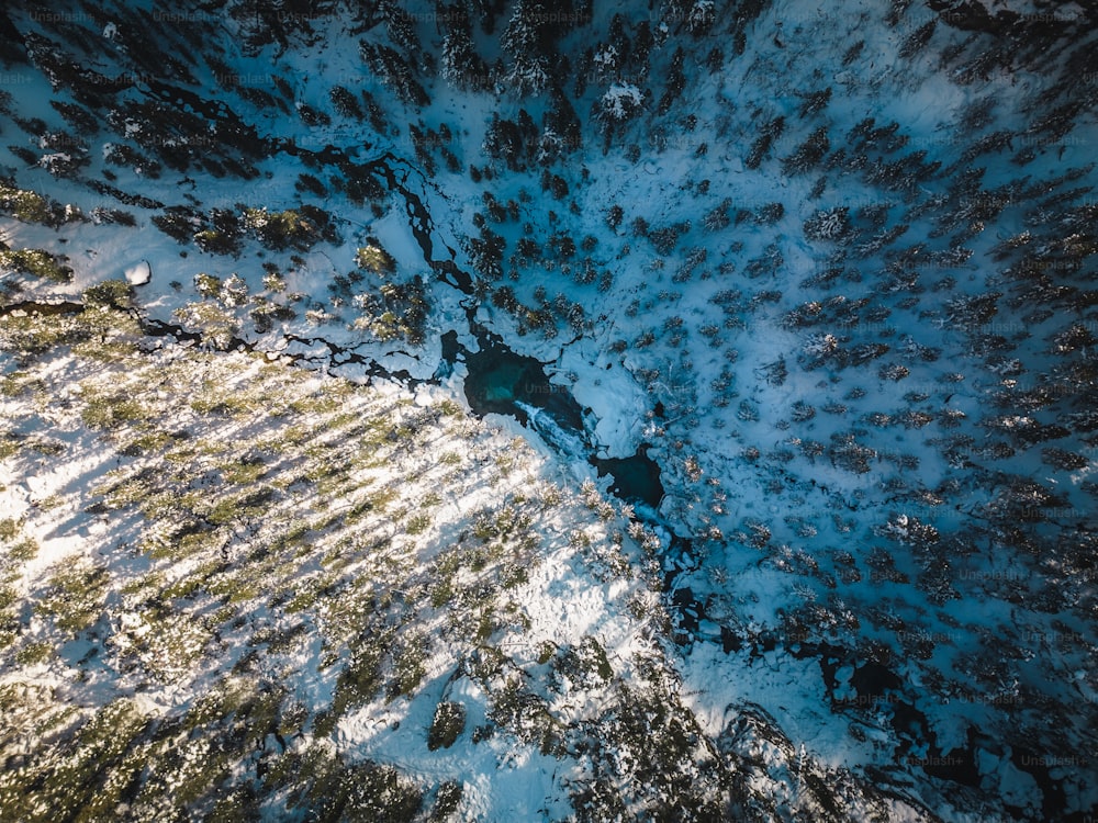 an aerial view of snow covered ground and trees