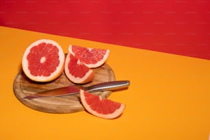 a grapefruit cut in half on a cutting board