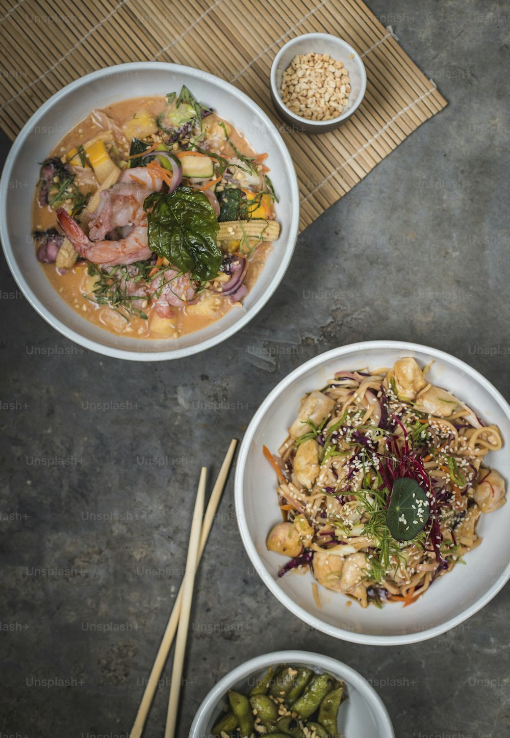 a table topped with bowls of food and chopsticks