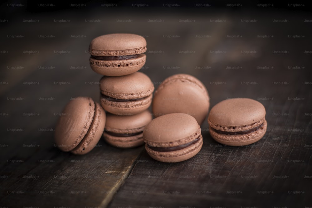 a pile of macaroons sitting on top of a wooden table