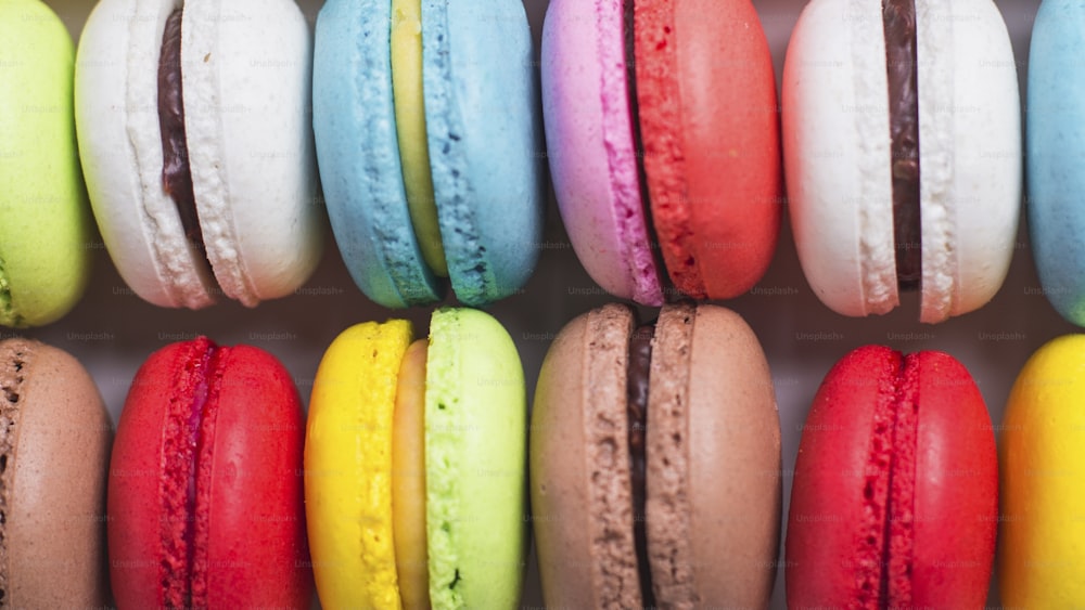 a bunch of colorful macaroons lined up in a row
