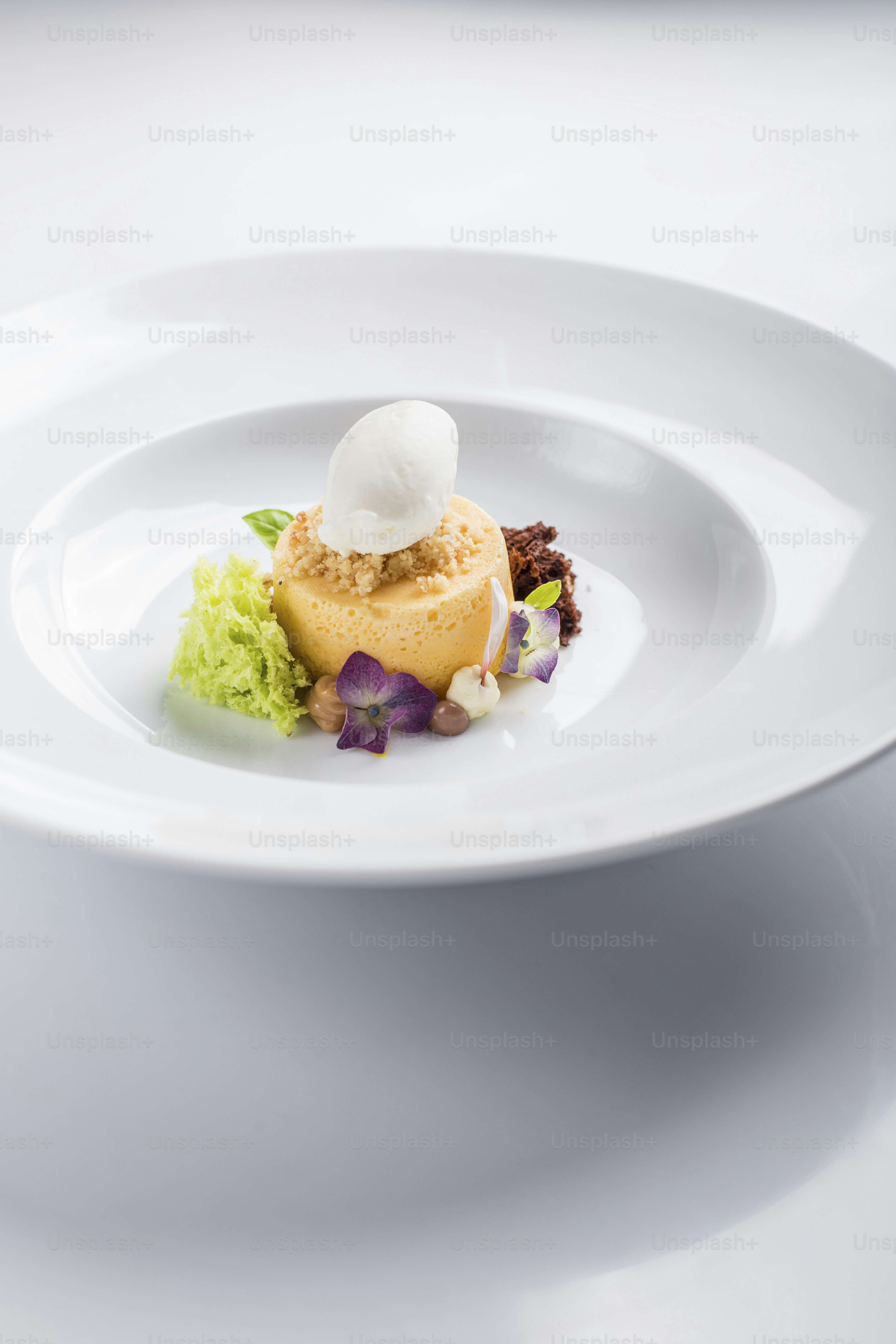 a white plate topped with a dessert covered in whipped cream