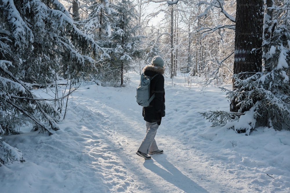 a person walking in the snow with a backpack