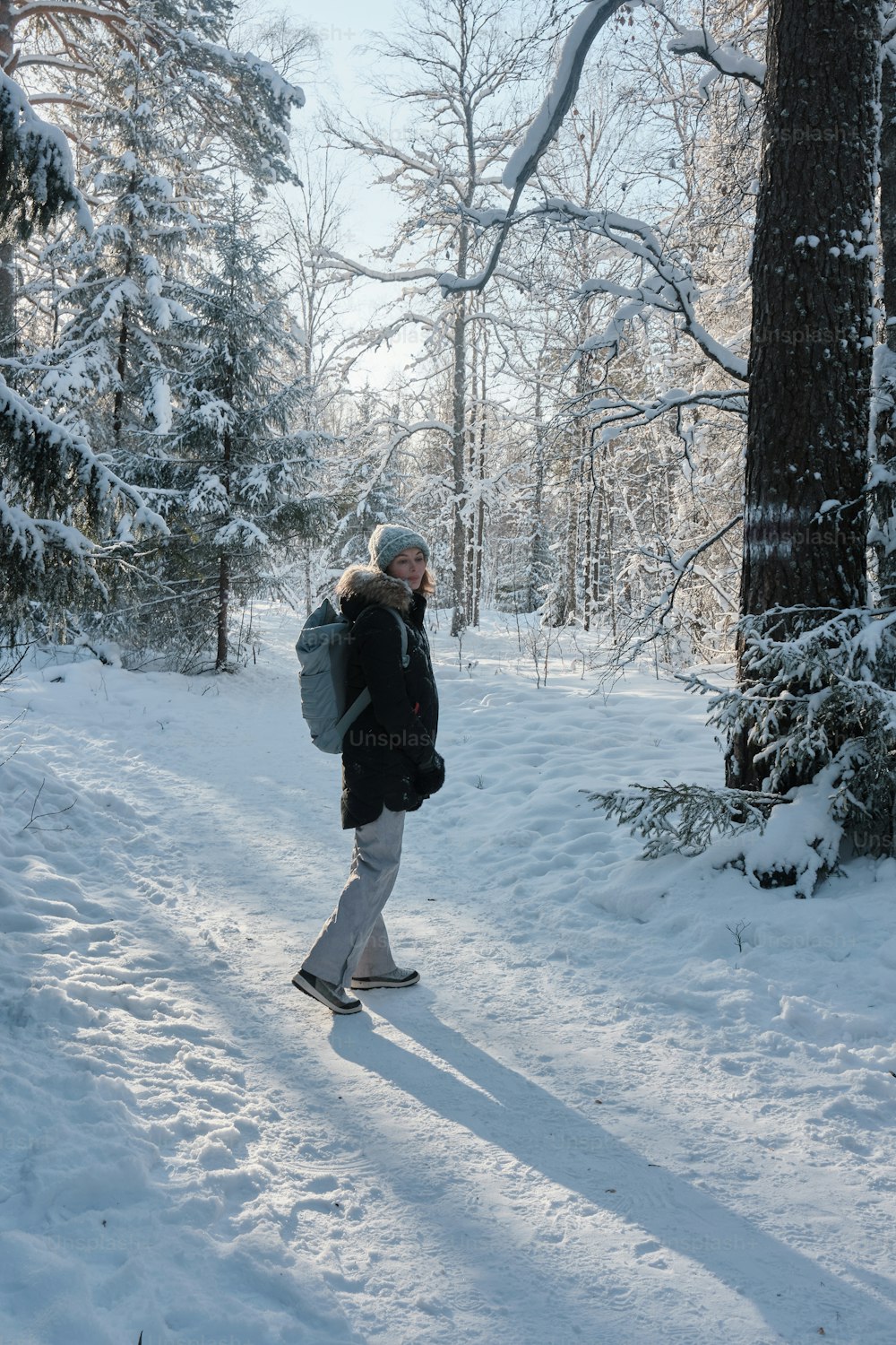 a person walking in the snow with a backpack