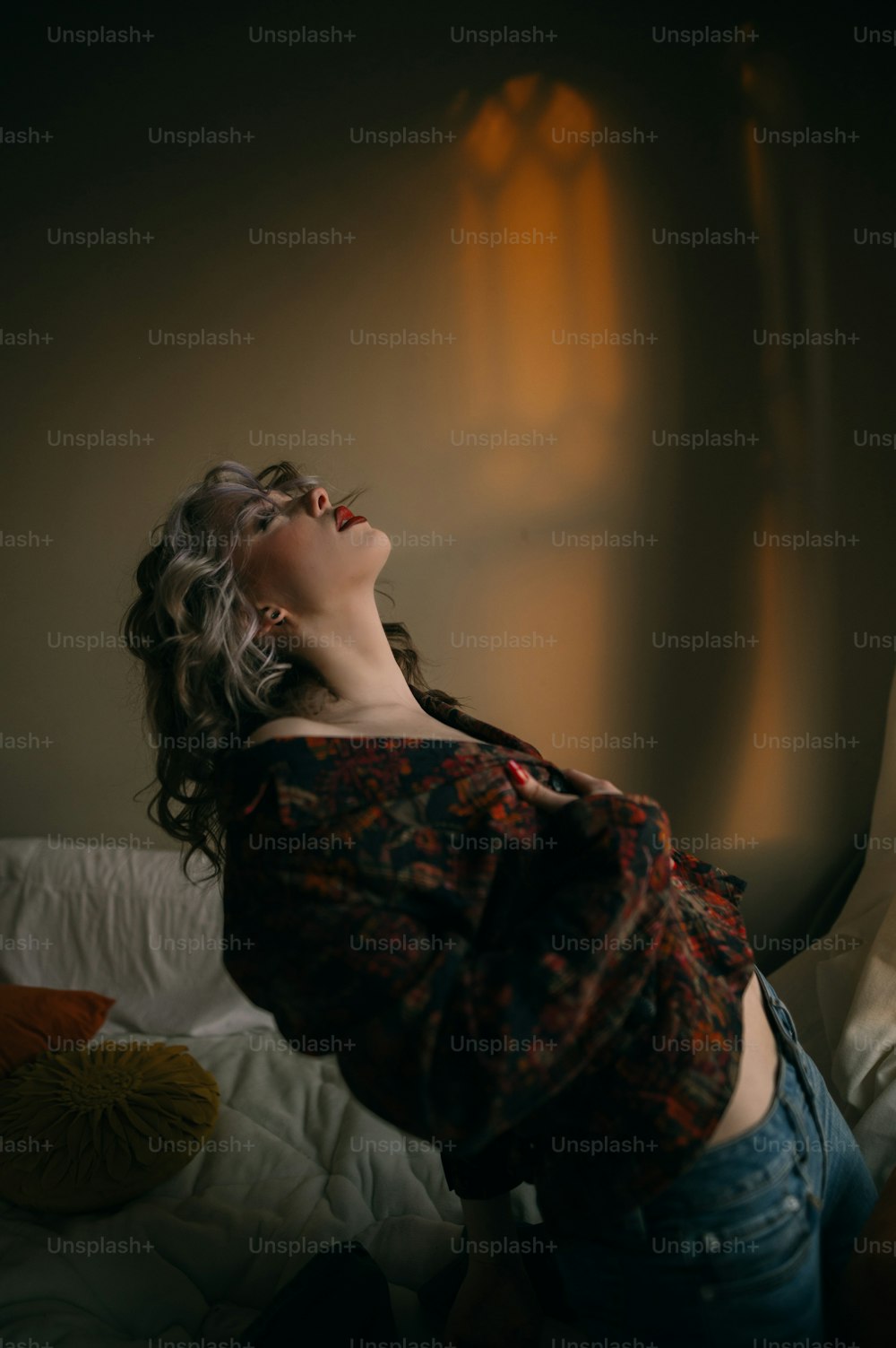 a woman laying on a bed with her eyes closed