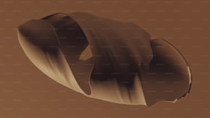 um objeto marrom é mostrado com um fundo marrom