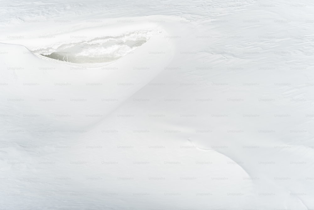 a man riding a snowboard down a snow covered slope