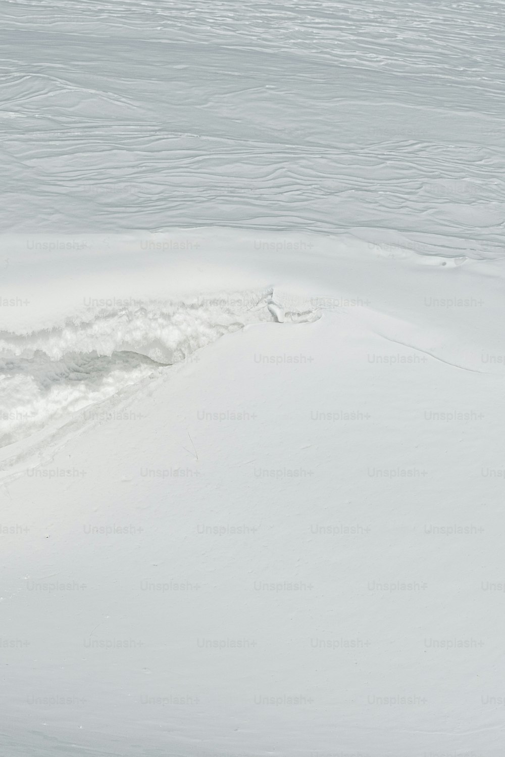 a man riding skis down a snow covered slope