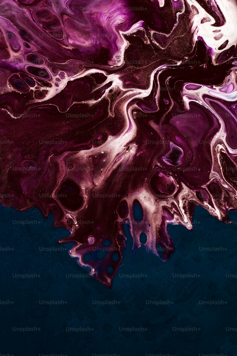 a purple and black substance floating in the water