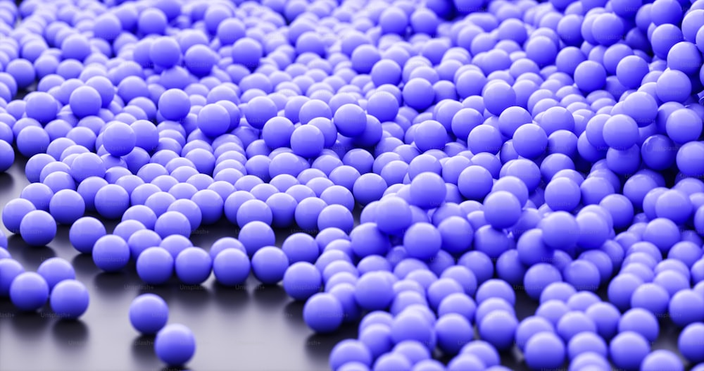 a large group of blue balls on a black surface