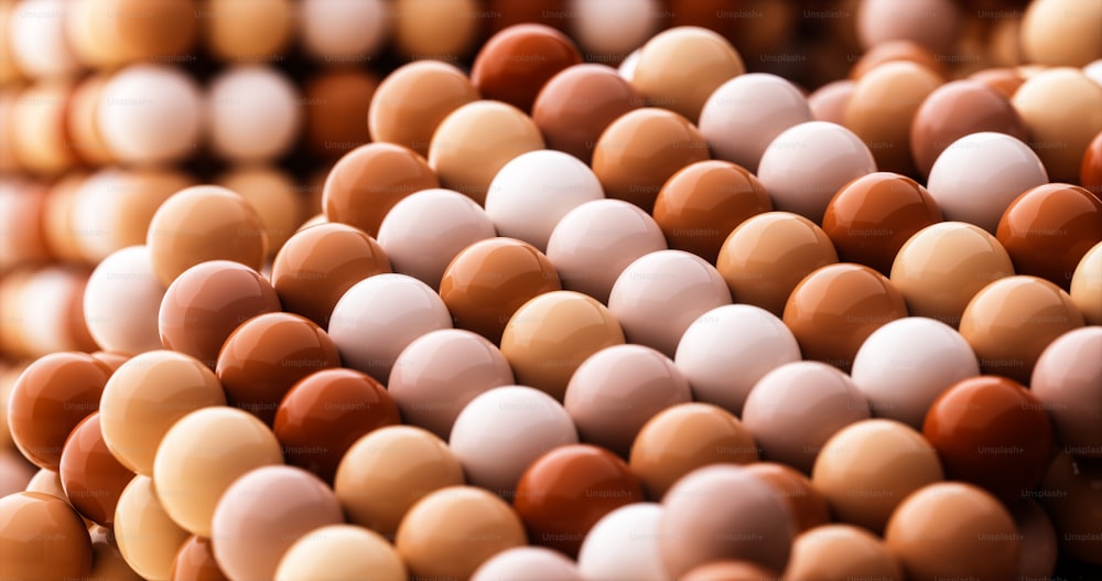 a close up of a bunch of brown and white eggs