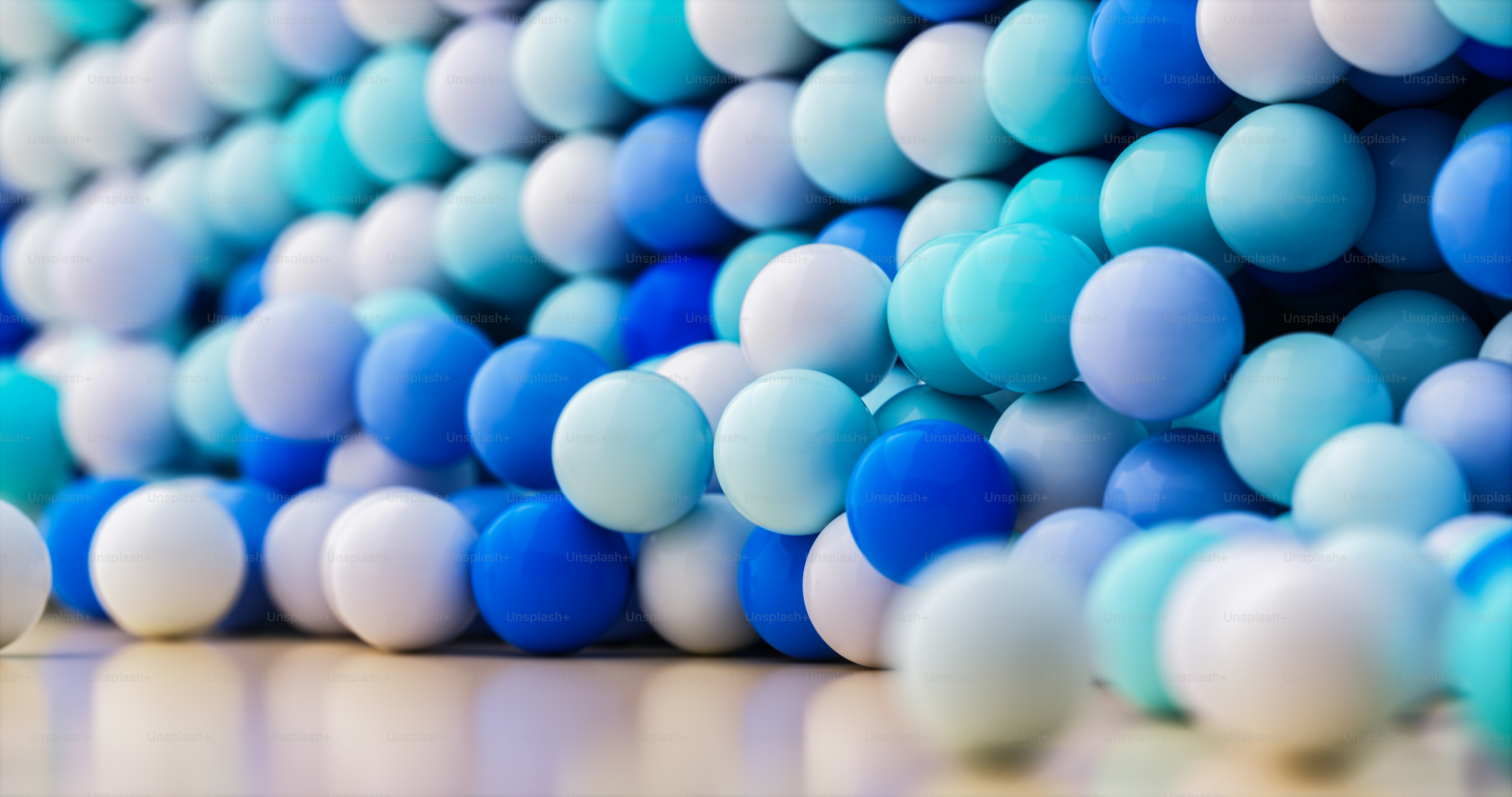 a bunch of blue and white balloons on a table