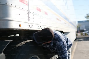 Ein Mann lehnt an der Seite eines großen Lastwagens