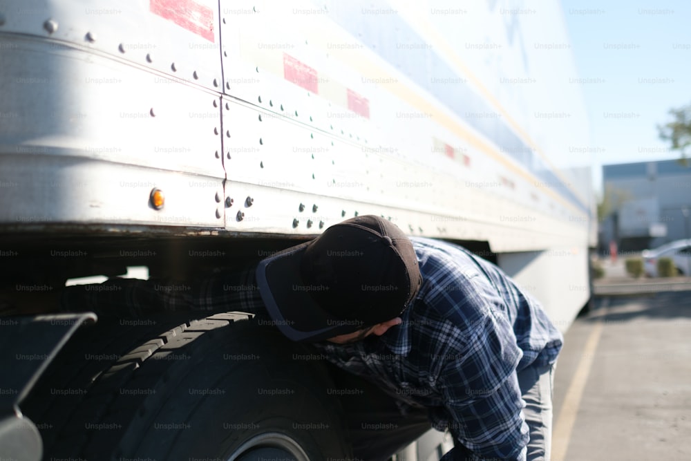 a man leaning on the side of a large truck