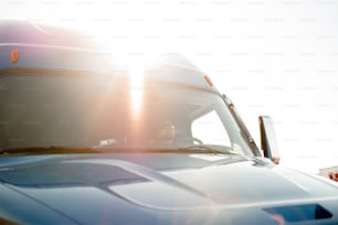 a close up of a bus with the sun shining through the windshield