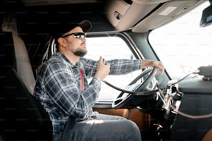 a man sitting in the drivers seat of a truck