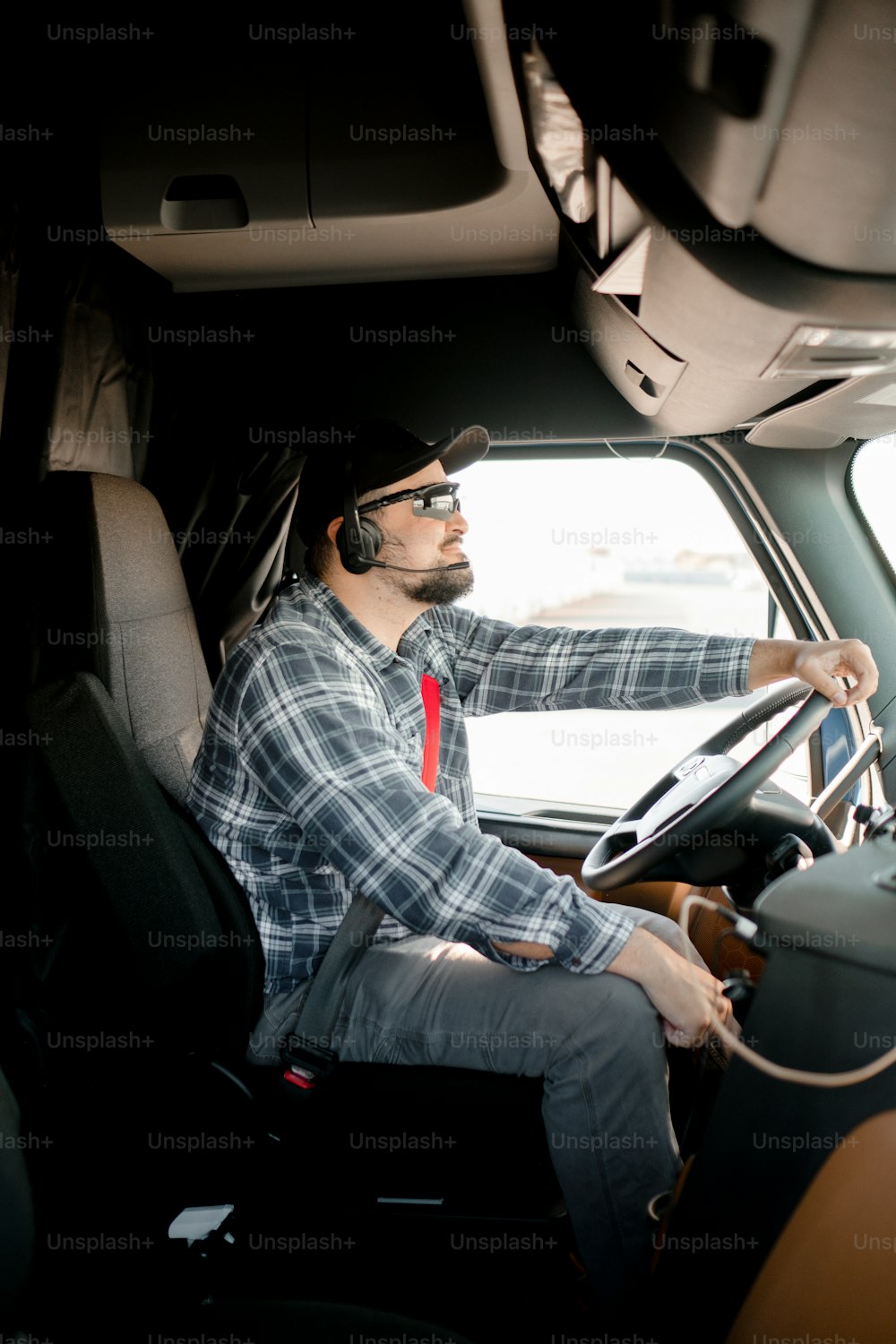 a man sitting in the driver's seat of a truck