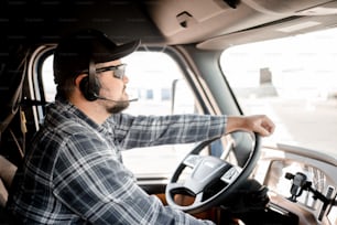 a man driving a truck wearing a headset