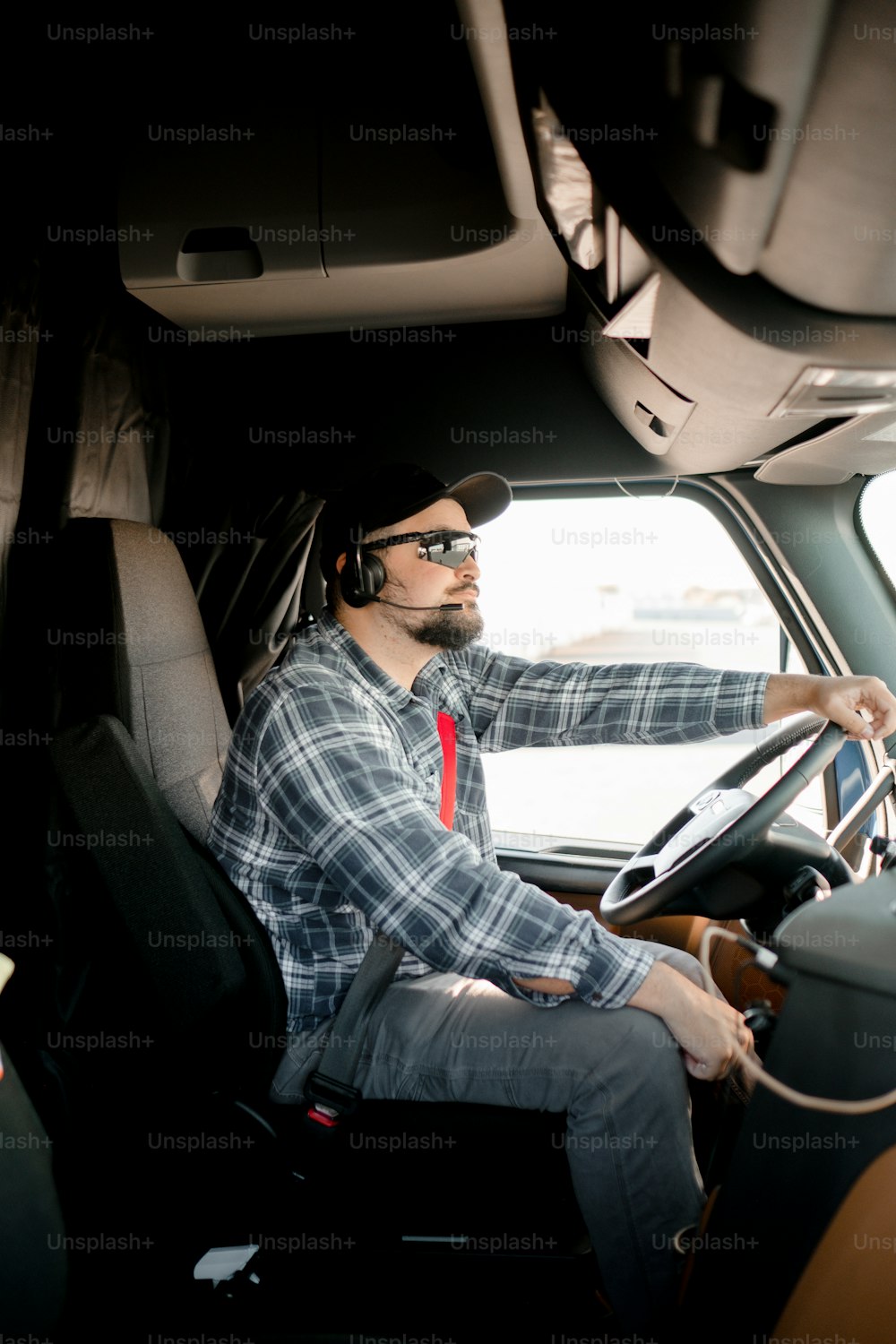 a man driving a truck with a steering wheel