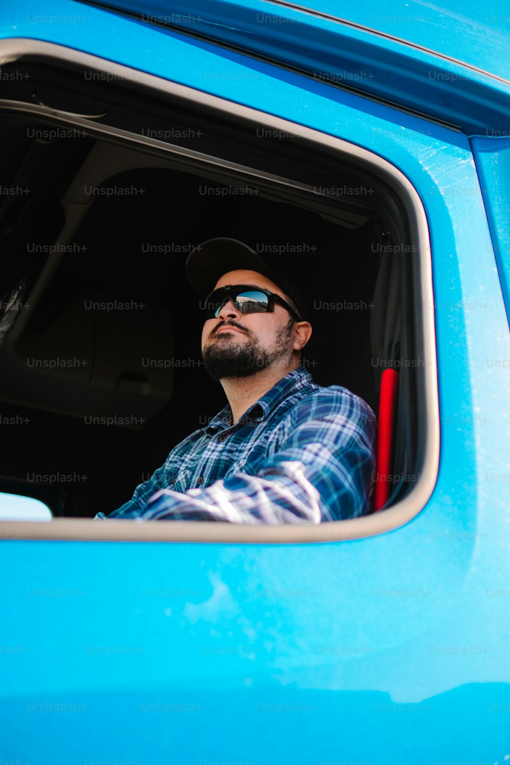 a man sitting in the back of a blue truck