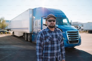 a man standing in front of a semi truck