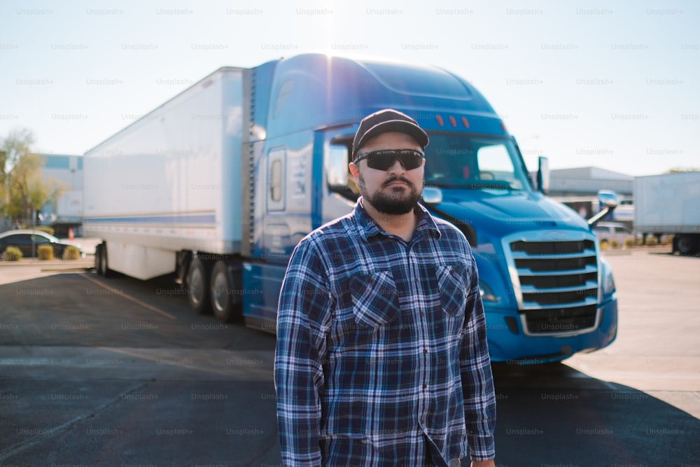 a man standing in front of a semi truck