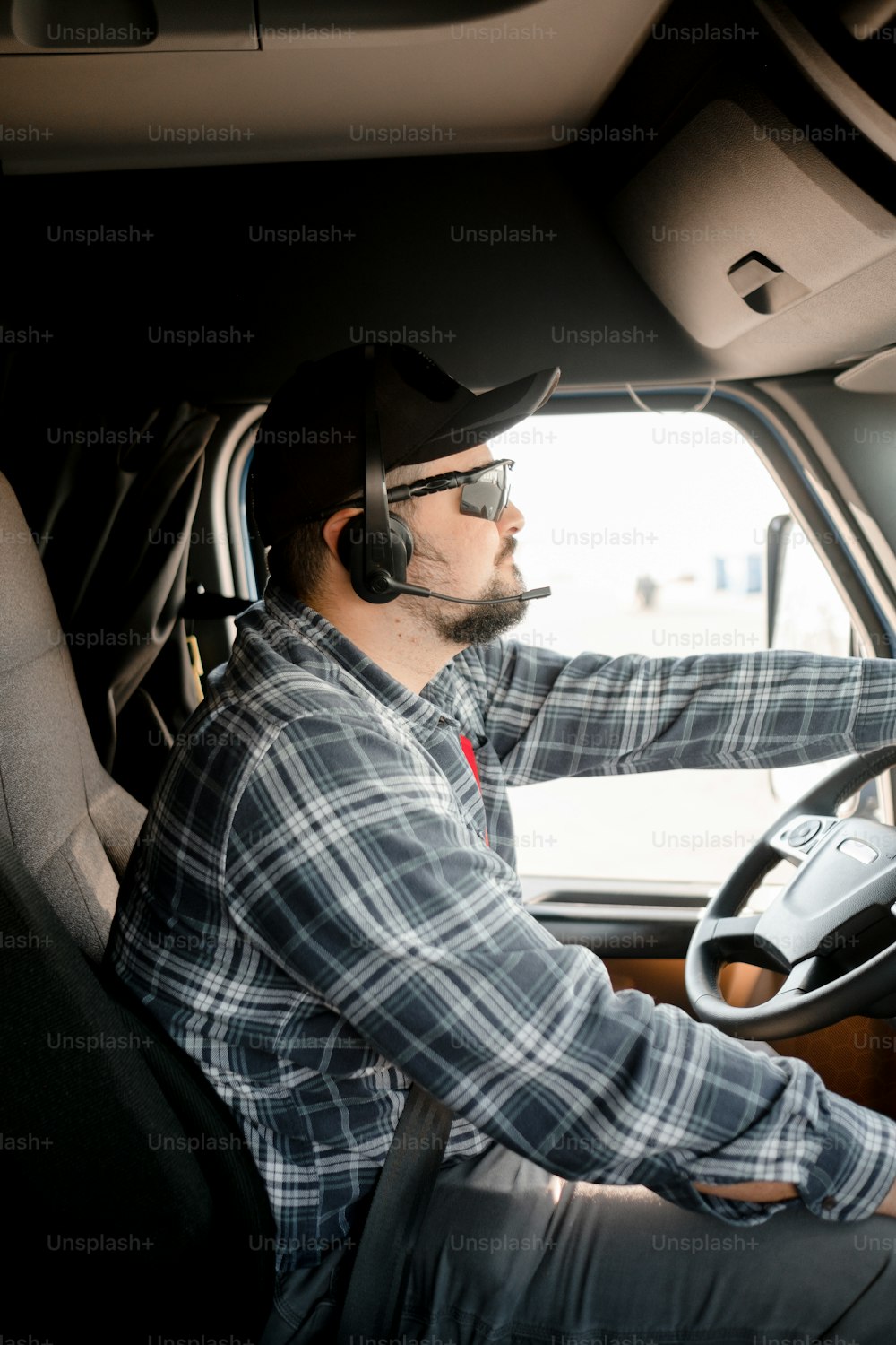 a man driving a truck wearing a headset