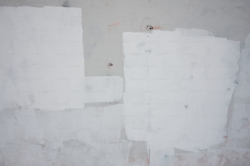 a red fire hydrant sitting next to a white wall