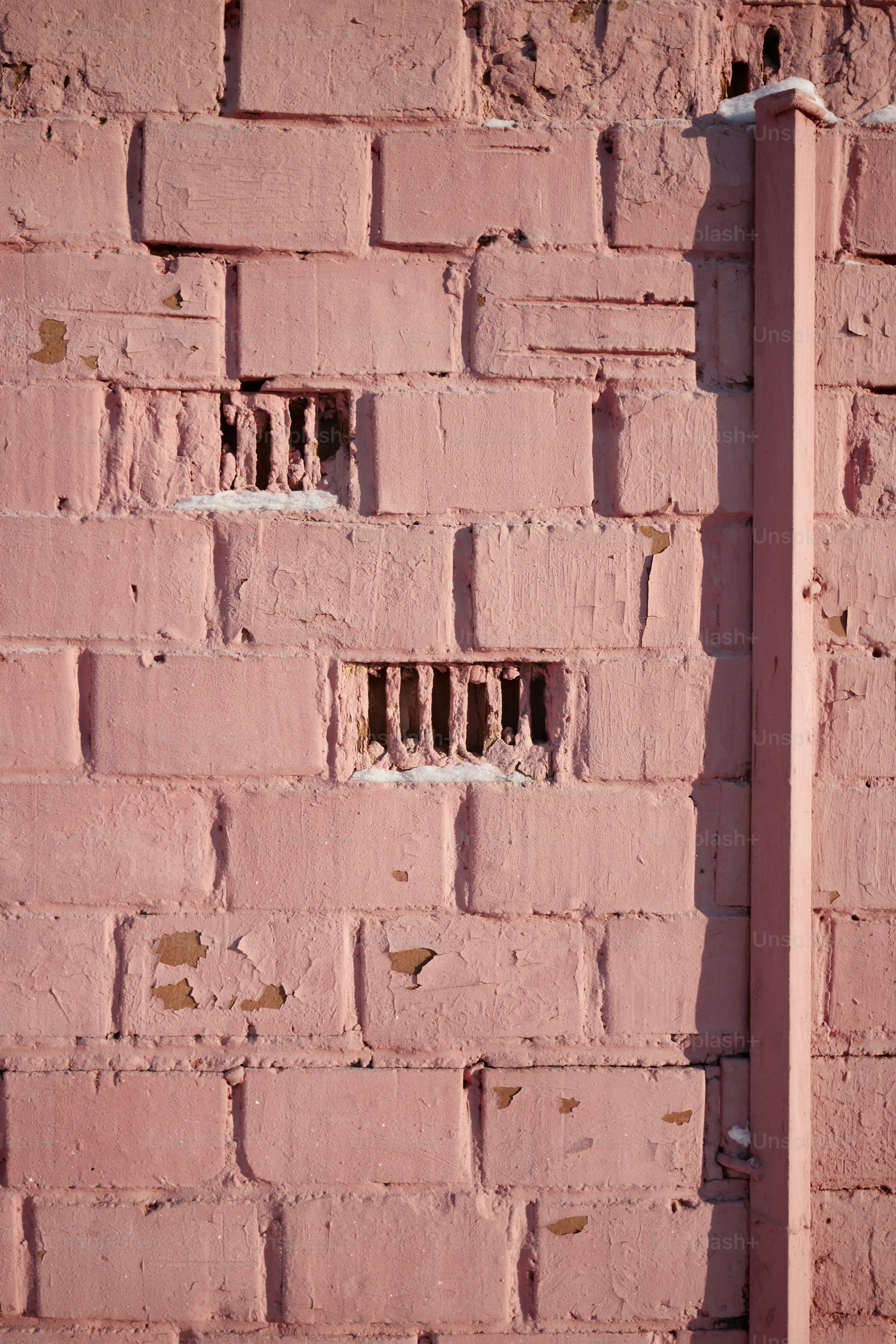 A red brick wall with holes in it photo brick background image on