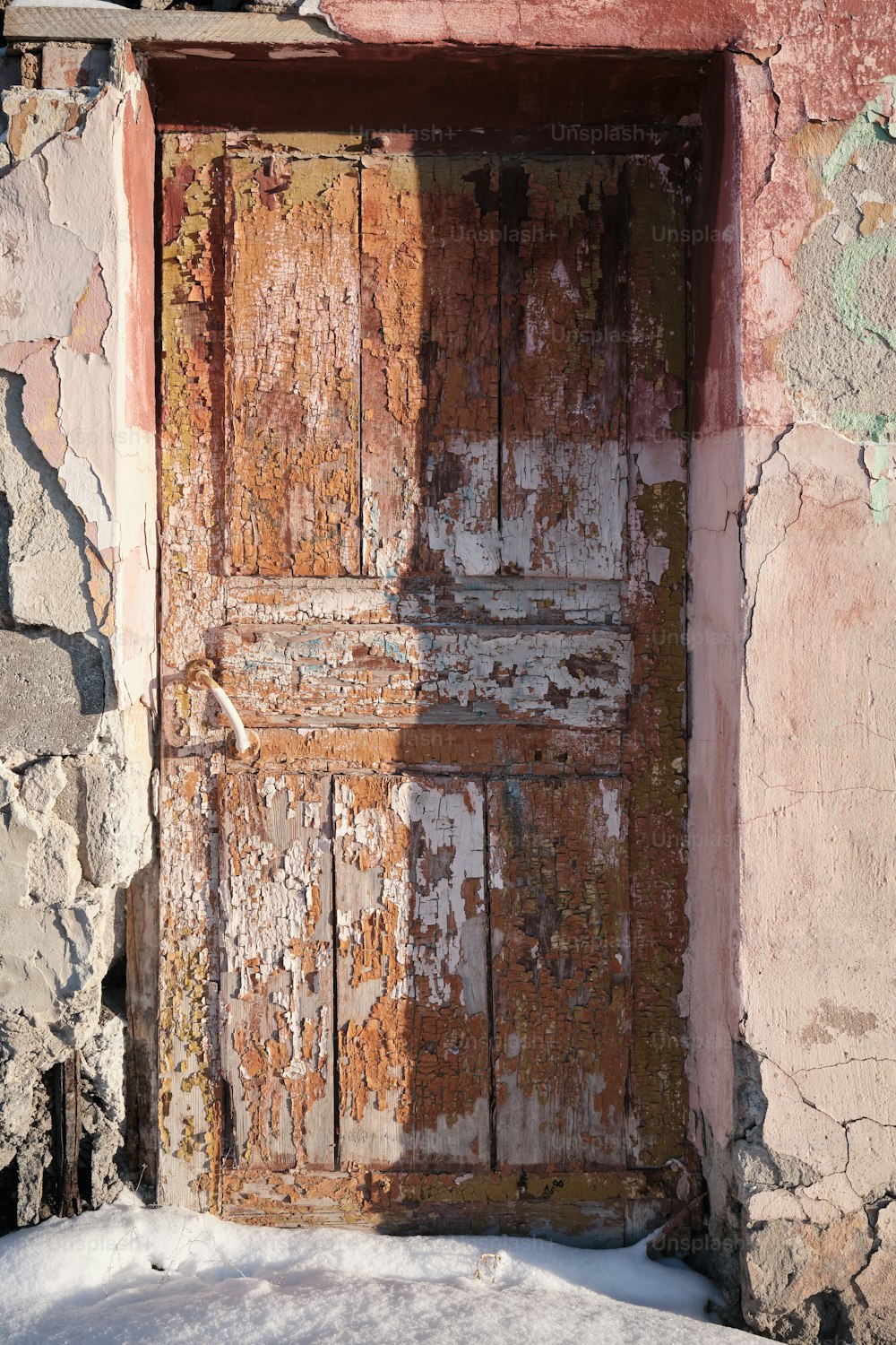 an old wooden door with peeling paint on it