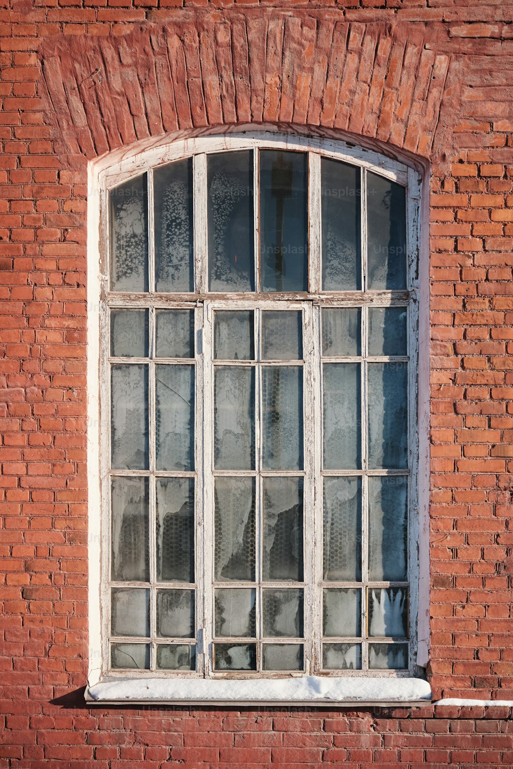 a red brick building with a white window