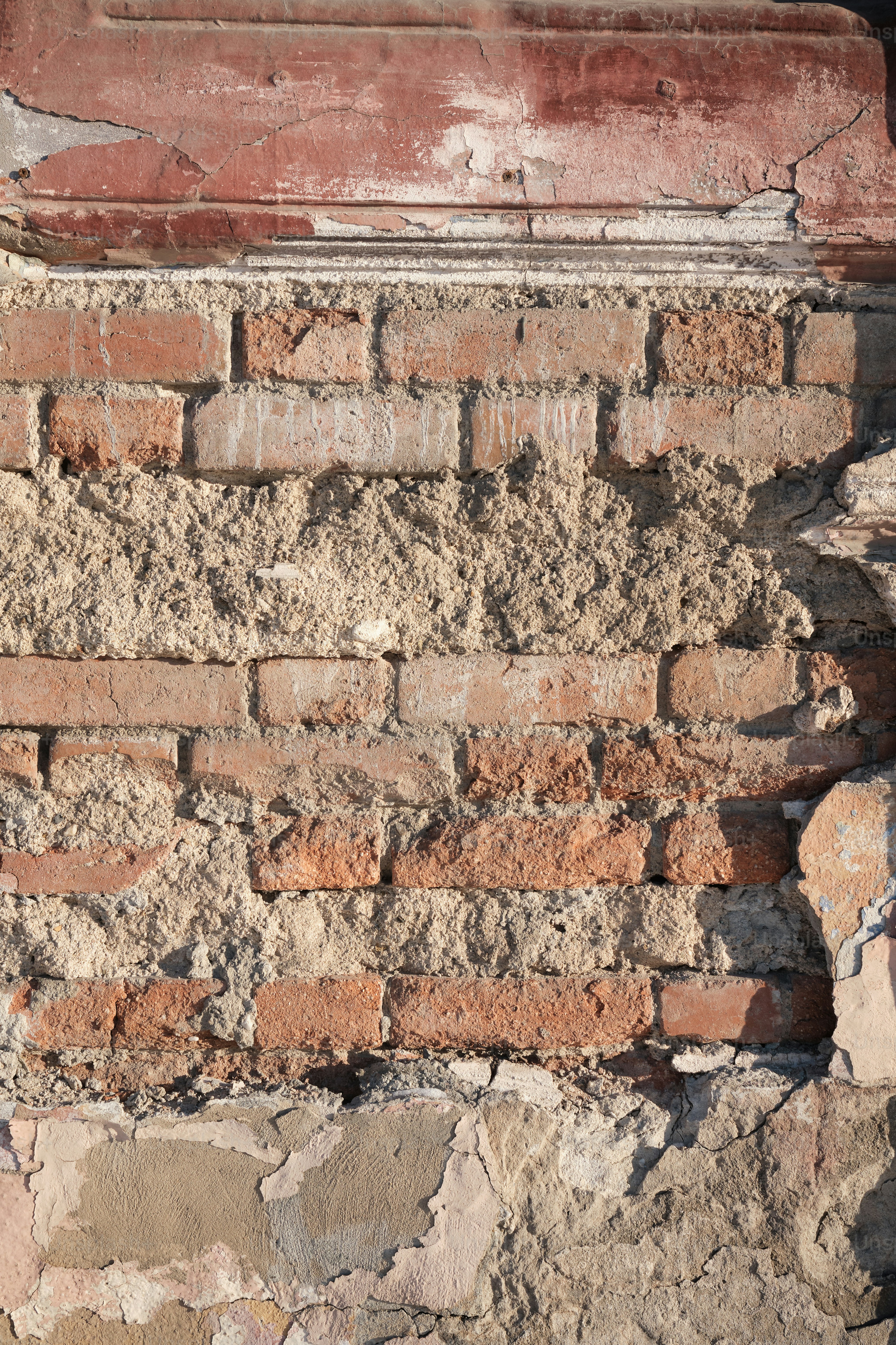 A brick wall with a clock on the side of it photo – Architecture Image ...
