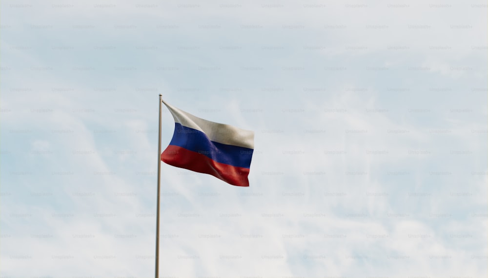 a flag flying in the wind with a blue sky in the background