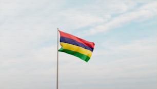 a rainbow colored flag flying in the wind