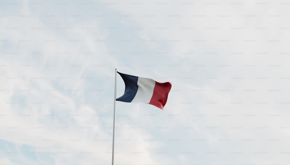 the flag of france is flying high in the sky
