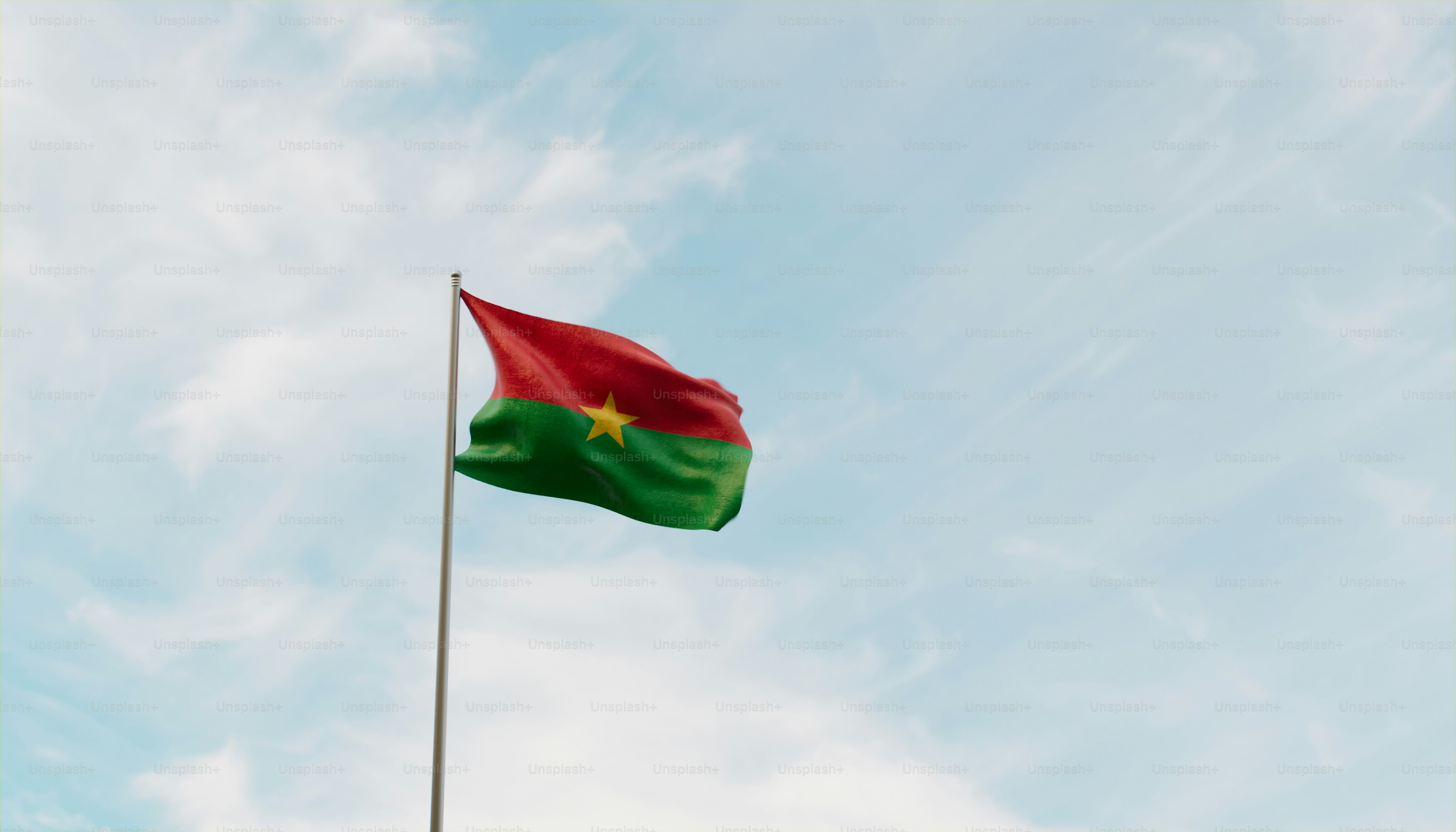 a flag flying high in the sky on a sunny day