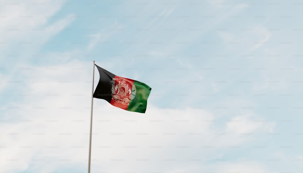 a flag flying in the wind with a sky background