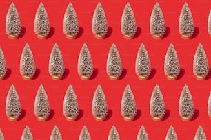 a red background with a pattern of small trees