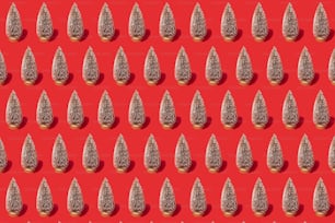 a red background with a lot of small silver objects