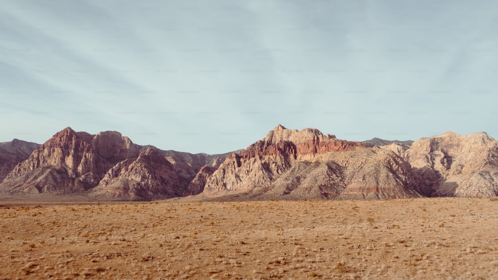 a large mountain range in the middle of a desert