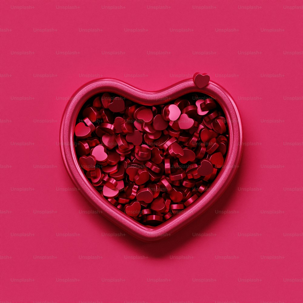 a heart shaped container filled with red confetti