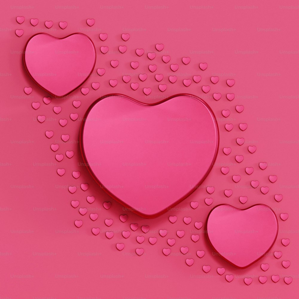 a pink background with three hearts on it