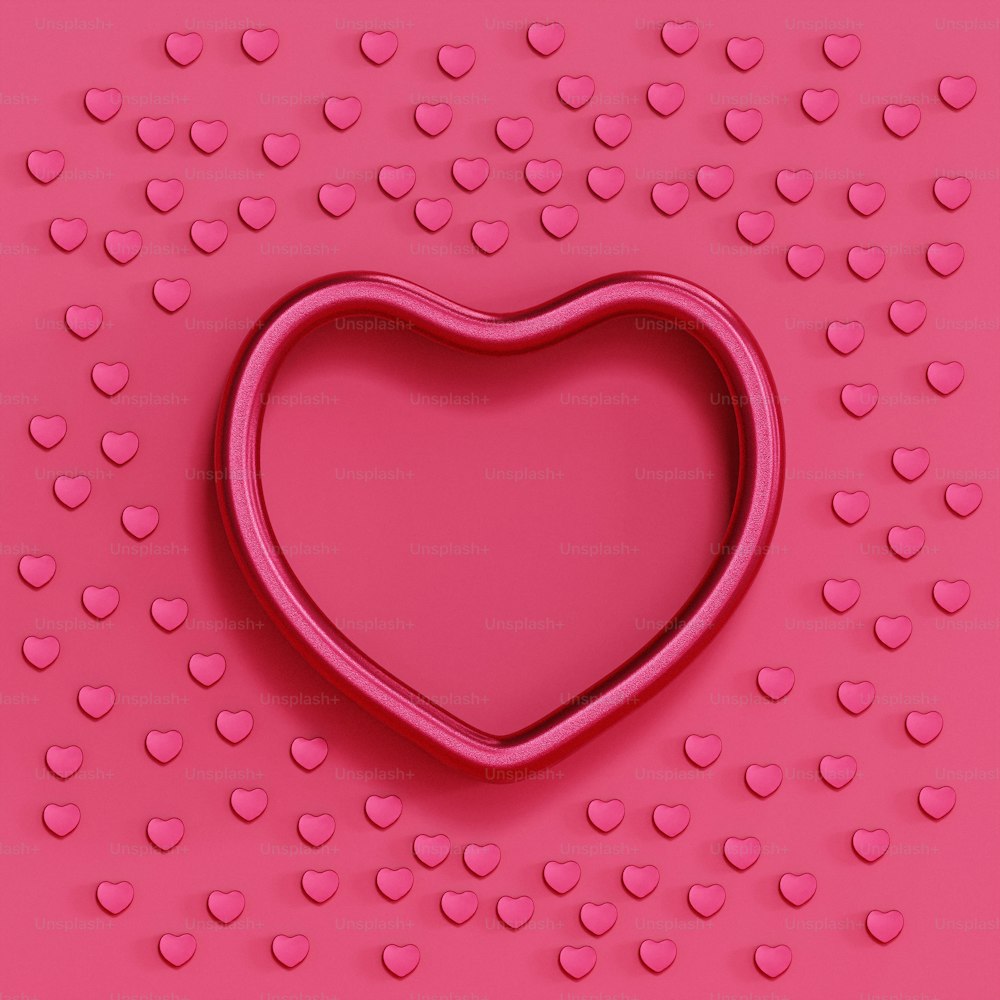 a cookie cutter shaped like a heart on a pink background